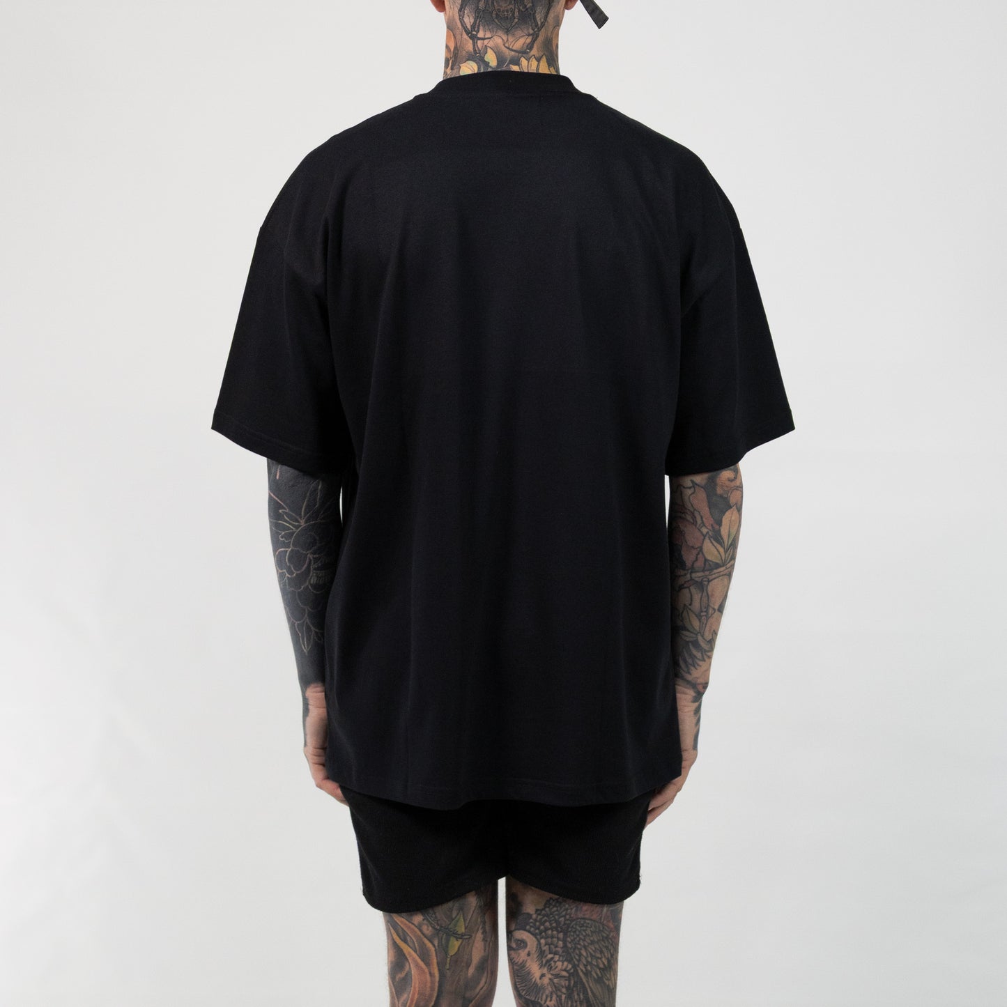 Foundation Heavy Tee oversized fit by Versant Studios, worn by Nick, heavily tattooed model Back
