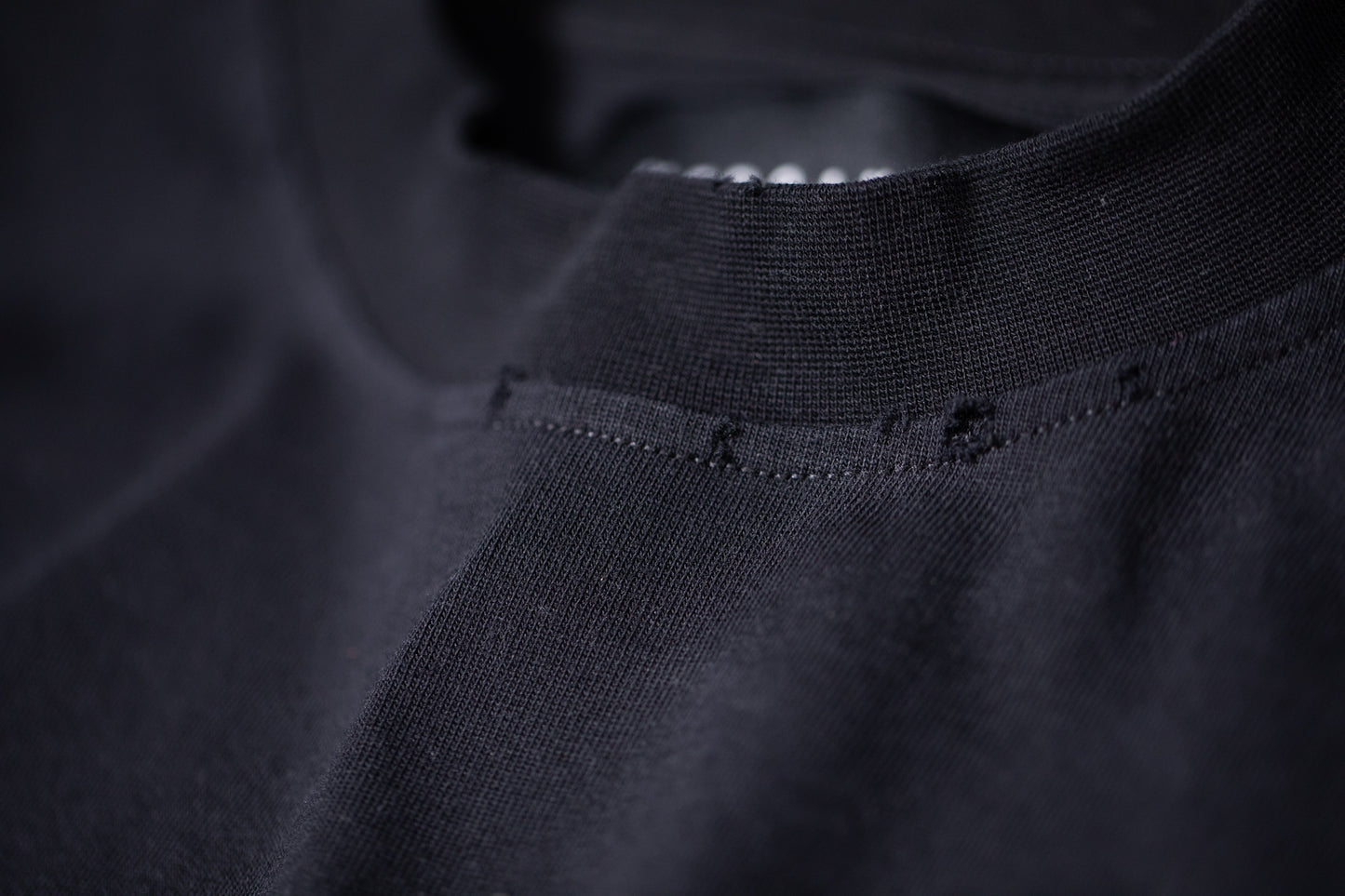 Close-up on the Distressed Vintage Foundation Tee by Versant Studios neckline