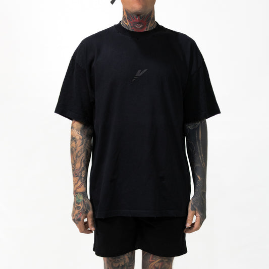 Distressed Vintage Foundation Tee close-up of vintage wash finish by Versant Studios worn by Nick, heavily tattooed model