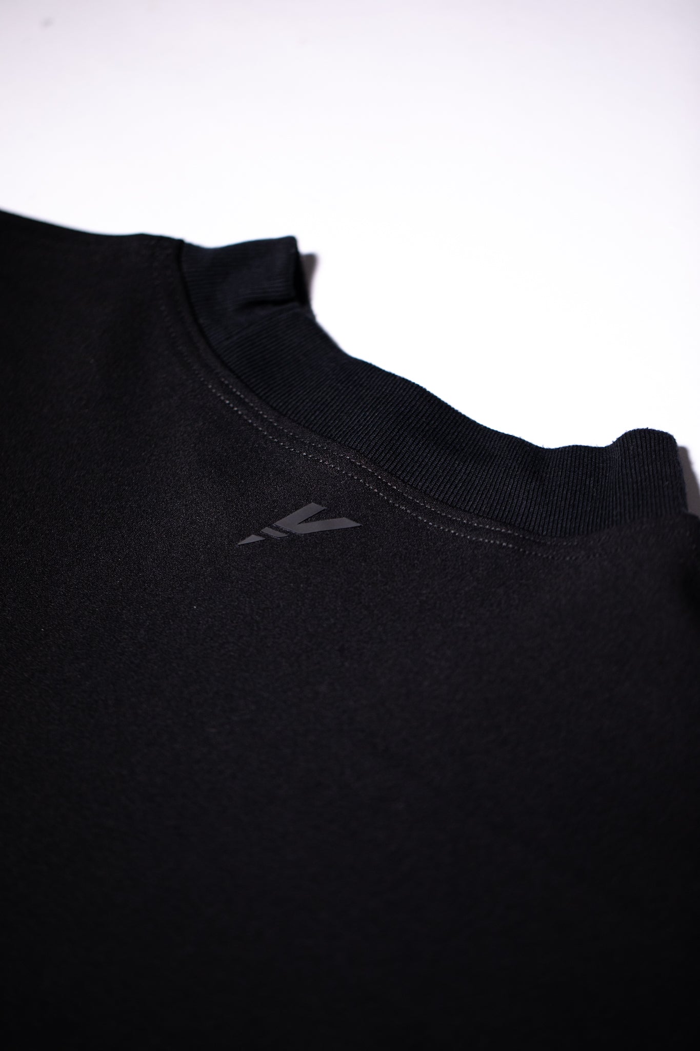 Batwing Oversized Tee back view neck detail by Versant Studios lay flat